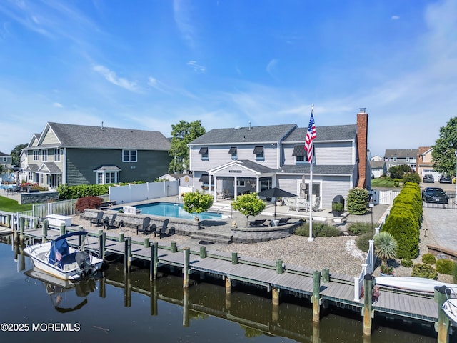 1510 Bel Aire Ct E, Point Pleasant, NJ 08742 - back of property featuring a fenced backyard, a water view, a residential view, and a patio area