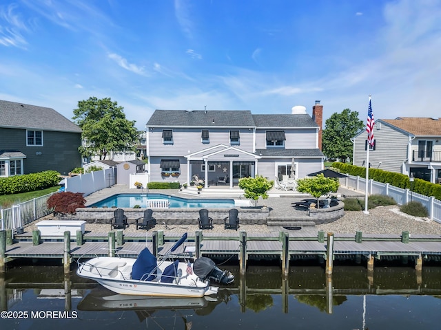1510 Bel Aire Ct E, Point Pleasant, NJ 08742 - rear view of house with a water view, a fenced backyard, a patio, and a chimney