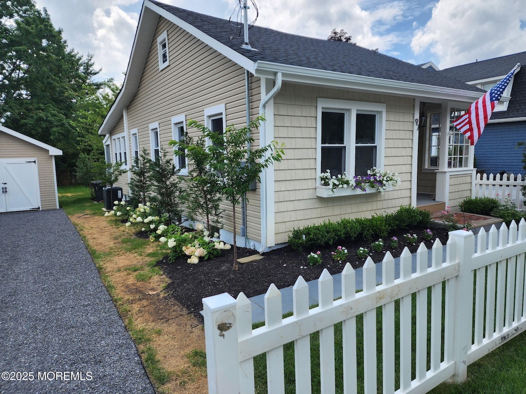 97 Asbury Ave, Atlantic Highlands, NJ 07716 - view of front of house with an outdoor structure and roof with shingles