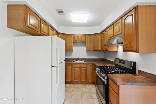10 Haven Dr Unit B, Matawan, NJ 07747 - kitchen featuring freestanding refrigerator, stainless steel gas range, under cabinet range hood, dark countertops, and brown cabinetry