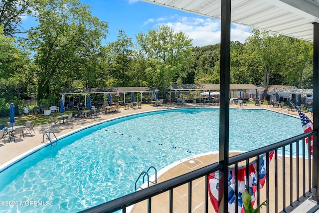 10 Haven Dr Unit B, Matawan, NJ 07747 - community pool with view of wooded area, a patio area, and a pergola