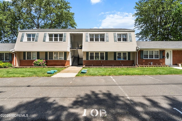 10 Haven Dr Unit B, Matawan, NJ 07747 - view of front facade with brick siding, a front yard, and uncovered parking