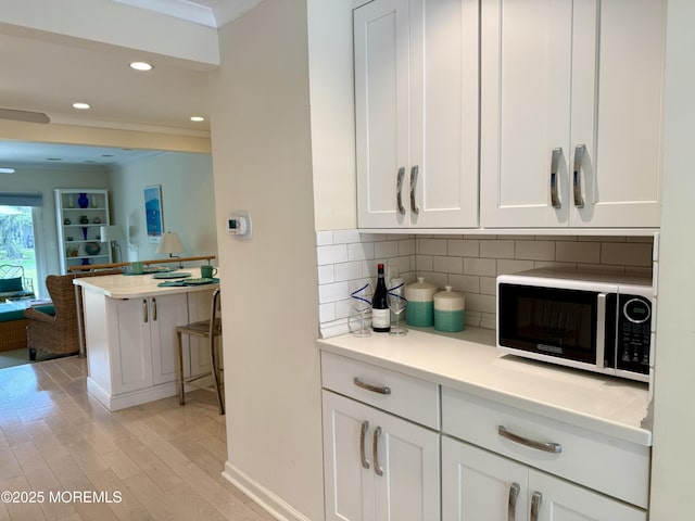 68 Linden Ct, Spring Lake Heights, NJ 07762 - bar area featuring crown molding, light wood-style flooring, tasteful backsplash, and recessed lighting