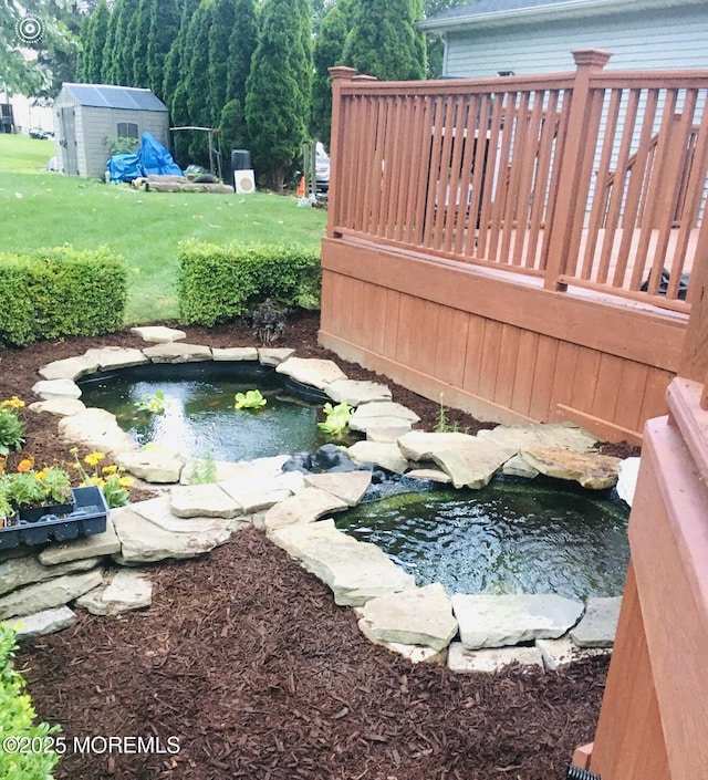 70 Desai Ct, Freehold, NJ 07728 - view of swimming pool with a garden pond, a shed, and a wooden deck