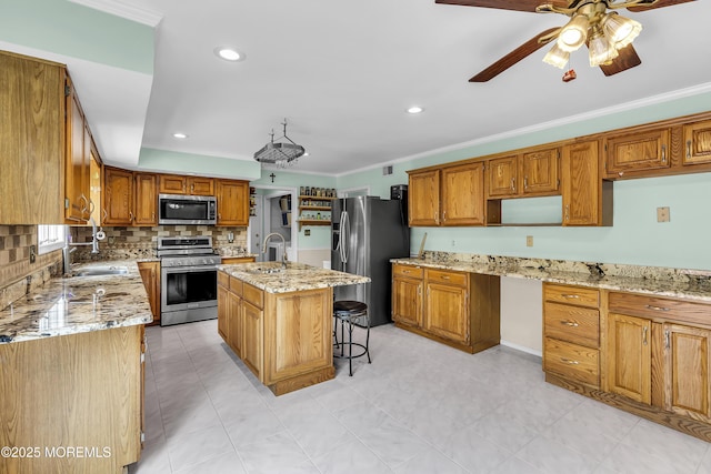70 Desai Ct, Freehold, NJ 07728 - kitchen with stainless steel appliances, a ceiling fan, brown cabinets, light stone counters, and ornamental molding