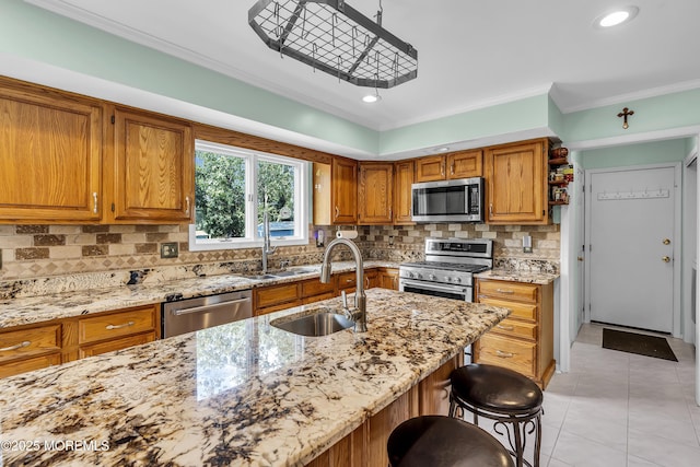 70 Desai Ct, Freehold, NJ 07728 - kitchen featuring stainless steel appliances, brown cabinets, light stone countertops, crown molding, and light tile patterned flooring