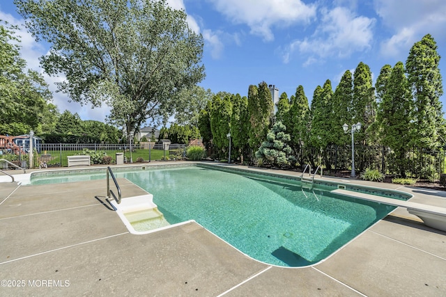70 Desai Ct, Freehold, NJ 07728 - view of pool featuring a patio area, a diving board, and view of scattered trees