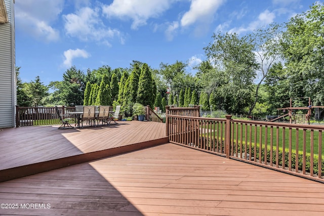 70 Desai Ct, Freehold, NJ 07728 - wooden terrace with outdoor dining area, view of scattered trees, a playground, and a yard