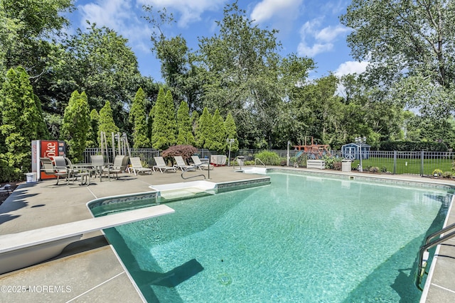 70 Desai Ct, Freehold, NJ 07728 - view of pool with a patio, a diving board, and view of wooded area