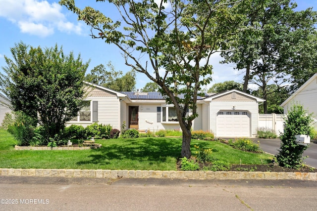 620 Pacific Ave, Beachwood, NJ 08722 - single story home featuring an attached garage, roof mounted solar panels, and asphalt driveway