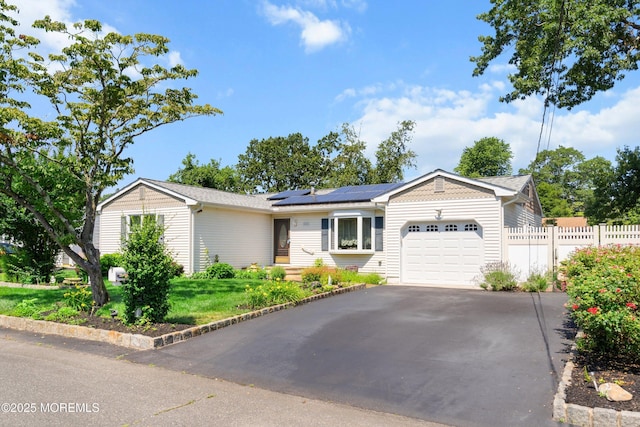 620 Pacific Ave, Beachwood, NJ 08722 - ranch-style house featuring an attached garage, driveway, and solar panels