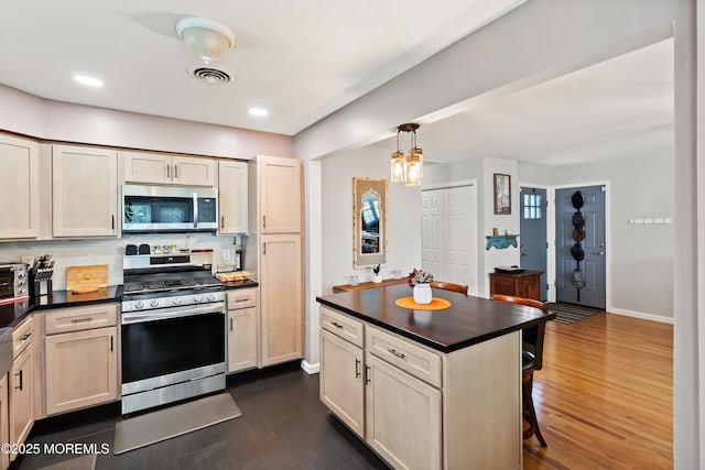 1086 Edgebrook Dr S, Toms River, NJ 08757 - kitchen with appliances with stainless steel finishes, dark countertops, a kitchen breakfast bar, dark wood finished floors, and recessed lighting