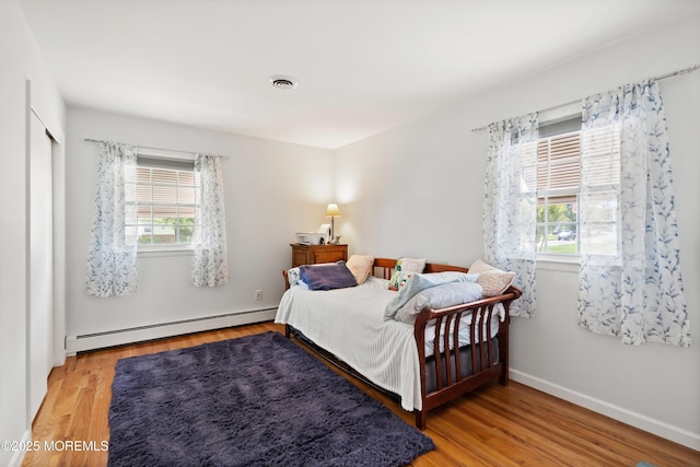 1086 Edgebrook Dr S, Toms River, NJ 08757 - bedroom with baseboard heating and wood finished floors