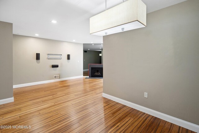 13 Jill Ct, Franklin Twp, NJ 08873 - unfurnished living room with light wood-type flooring, a fireplace with flush hearth, and recessed lighting