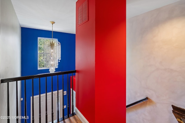13 Jill Ct, Franklin Twp, NJ 08873 - stairs featuring a chandelier and wood finished floors