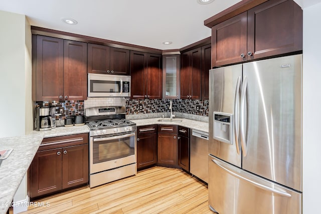 13 Jill Ct, Franklin Twp, NJ 08873 - kitchen featuring stainless steel appliances, light wood finished floors, decorative backsplash, glass insert cabinets, and light stone countertops