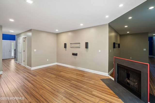 13 Jill Ct, Franklin Twp, NJ 08873 - unfurnished living room with light wood-style floors, a fireplace with flush hearth, and recessed lighting