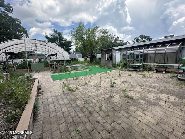 570 Mantoloking Rd, Brick, NJ 08723 - view of patio / terrace with a greenhouse and an outbuilding