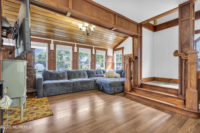 614 Bay Blvd, Bayville, NJ 08721 - living room featuring lofted ceiling, a chandelier, wood finished floors, and wood walls