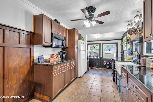 614 Bay Blvd, Bayville, NJ 08721 - kitchen with black microwave, freestanding refrigerator, ceiling fan, dark stone countertops, and ornamental molding