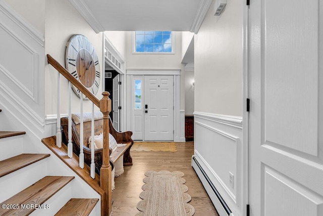 101 Taft Ct, Brick, NJ 08724 - entryway with baseboard heating, stairway, ornamental molding, light wood-style flooring, and a wainscoted wall