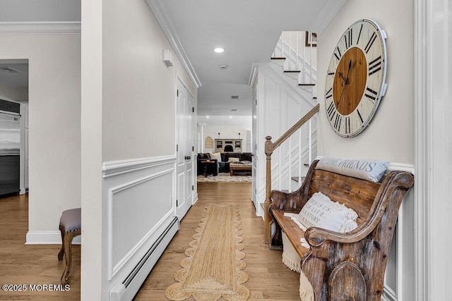 101 Taft Ct, Brick, NJ 08724 - corridor featuring a baseboard radiator, stairway, wood finished floors, ornamental molding, and recessed lighting