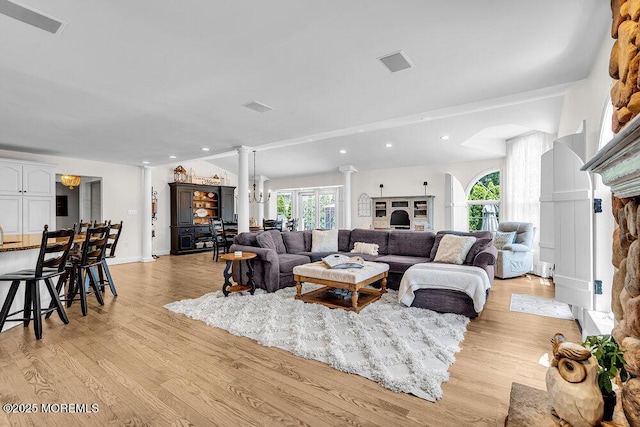 101 Taft Ct, Brick, NJ 08724 - living room featuring ornate columns, plenty of natural light, lofted ceiling, light wood-style floors, and recessed lighting