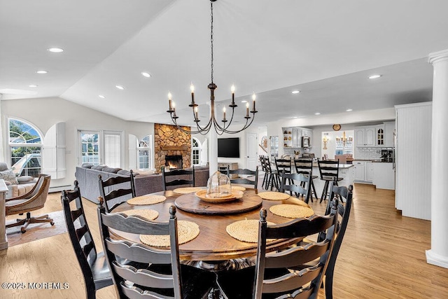 101 Taft Ct, Brick, NJ 08724 - dining room featuring lofted ceiling, a stone fireplace, light wood finished floors, recessed lighting, and ornate columns