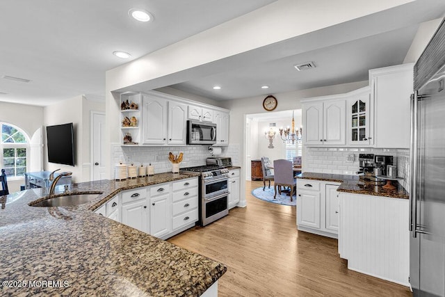 101 Taft Ct, Brick, NJ 08724 - kitchen featuring stainless steel appliances, white cabinetry, open shelves, decorative backsplash, and a chandelier