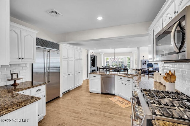 101 Taft Ct, Brick, NJ 08724 - kitchen featuring stainless steel appliances, white cabinetry, a peninsula, dark stone counters, and recessed lighting