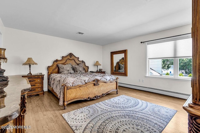 101 Taft Ct, Brick, NJ 08724 - bedroom featuring a baseboard heating unit and wood finished floors