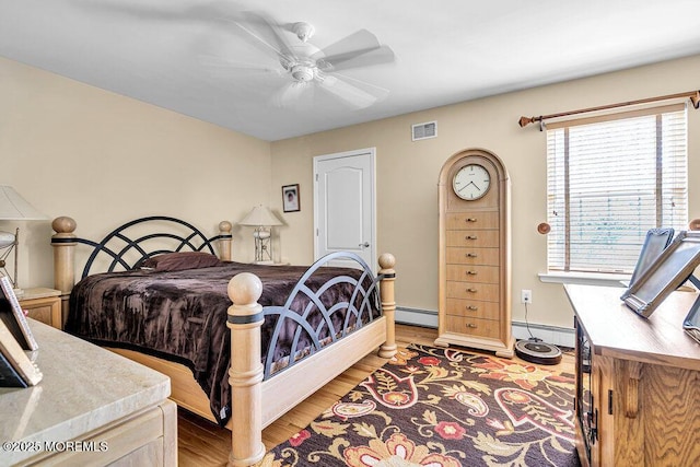 101 Taft Ct, Brick, NJ 08724 - bedroom with a baseboard heating unit, light wood-type flooring, and a ceiling fan
