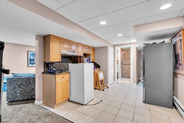 101 Taft Ct, Brick, NJ 08724 - kitchen featuring freestanding refrigerator, under cabinet range hood, a drop ceiling, baseboard heating, and light tile patterned floors