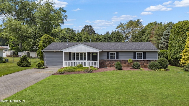 34 Traymore Rd, Freehold, NJ 07728 - view of front of house featuring covered porch, a front lawn, brick siding, driveway, and a shingled roof