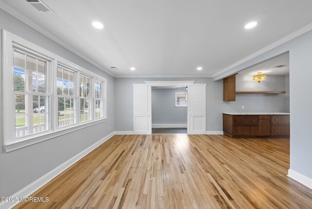 34 Traymore Rd, Freehold, NJ 07728 - unfurnished living room featuring ornamental molding, light wood-style floors, and recessed lighting