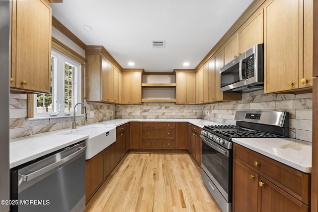 34 Traymore Rd, Freehold, NJ 07728 - kitchen featuring stainless steel appliances, open shelves, light wood finished floors, and backsplash