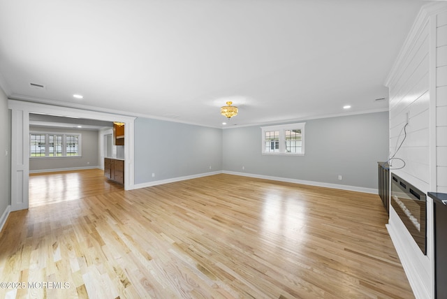 34 Traymore Rd, Freehold, NJ 07728 - unfurnished living room featuring crown molding, a large fireplace, plenty of natural light, light wood-style floors, and recessed lighting
