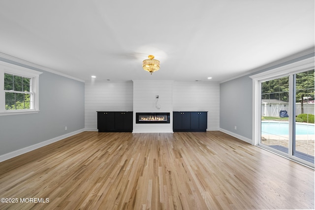 34 Traymore Rd, Freehold, NJ 07728 - unfurnished living room with ornamental molding, light wood-style flooring, a large fireplace, recessed lighting, and a chandelier