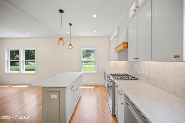 569 Ocean Blvd, Leonardo, NJ 07737 - kitchen featuring stainless steel appliances, light wood finished floors, decorative backsplash, a center island, and light stone countertops