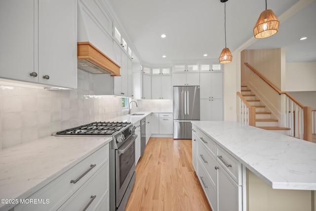 569 Ocean Blvd, Leonardo, NJ 07737 - kitchen with stainless steel appliances, light wood-style floors, light stone counters, decorative backsplash, and recessed lighting