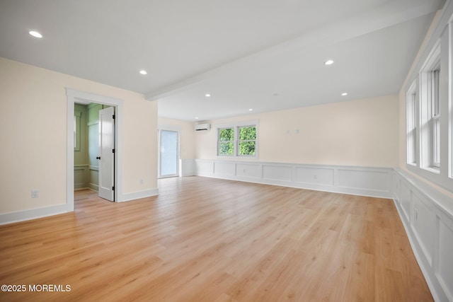 569 Ocean Blvd, Leonardo, NJ 07737 - unfurnished room with light wood-style flooring, wainscoting, recessed lighting, a wall unit AC, and a decorative wall