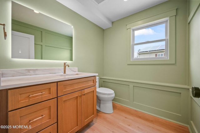 569 Ocean Blvd, Leonardo, NJ 07737 - bathroom featuring wood finished floors, a decorative wall, vanity, and wainscoting