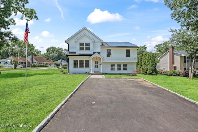 569 Ocean Blvd, Leonardo, NJ 07737 - view of front of house with a front yard and roof mounted solar panels