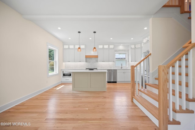 569 Ocean Blvd, Leonardo, NJ 07737 - kitchen featuring stainless steel dishwasher, light wood-style flooring, white cabinets, decorative backsplash, and recessed lighting