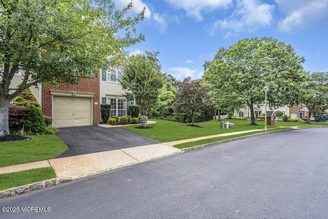 106 Tarpon Dr, Sea Girt, NJ 08750 - view of front of property featuring driveway, a front yard, an attached garage, and brick siding
