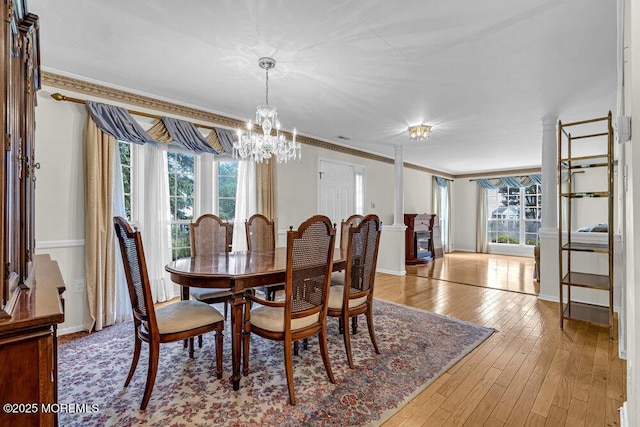 106 Tarpon Dr, Sea Girt, NJ 08750 - dining area with healthy amount of natural light, a chandelier, light wood-style floors, and crown molding