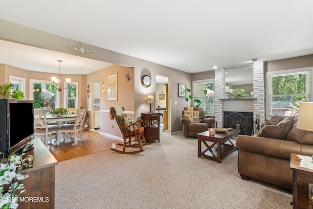 7 Plymouth Dr, Howell, NJ 07731 - living area featuring a chandelier, a fireplace, light carpet, and healthy amount of natural light