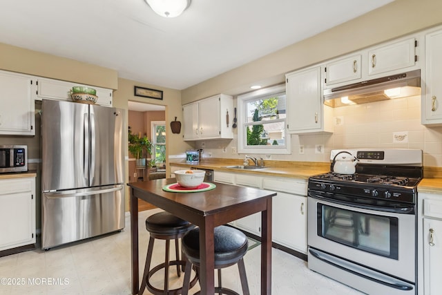 7 Plymouth Dr, Howell, NJ 07731 - kitchen with stainless steel appliances, under cabinet range hood, white cabinets, and backsplash