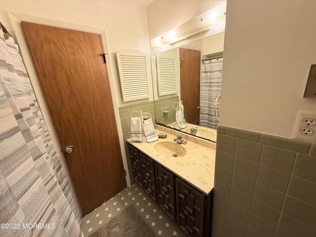 170 E Holly Ln Unit 105, Little Egg Harbor, NJ 08087 - bathroom featuring tile walls, vanity, and wainscoting