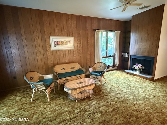 170 E Holly Ln Unit 105, Little Egg Harbor, NJ 08087 - sitting room featuring a ceiling fan, wood walls, a fireplace, and carpet flooring